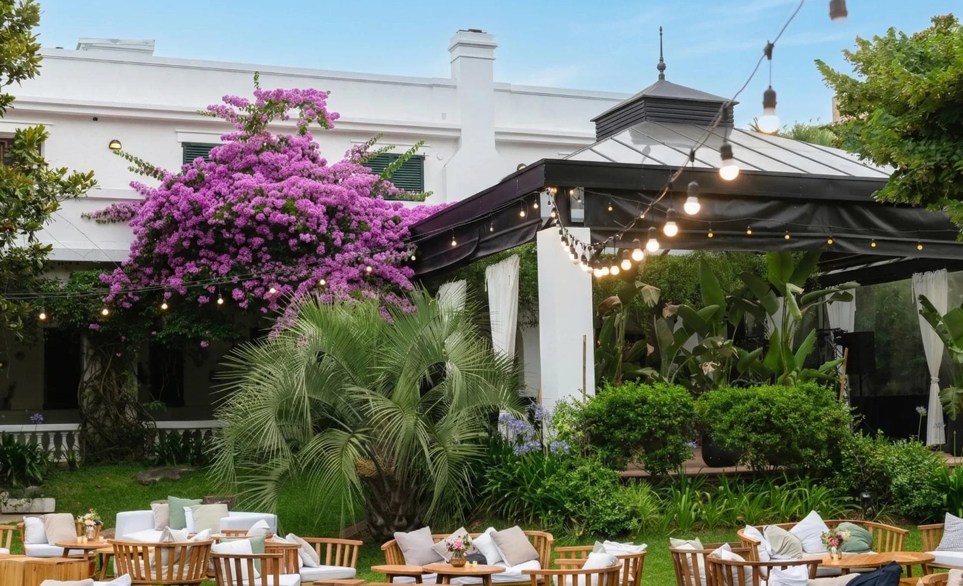 Jardín con santa rita florecida y la pérgola